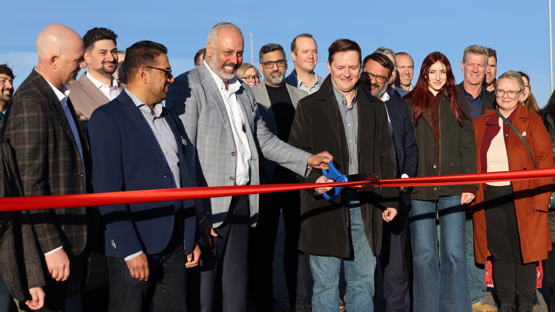 Cutting the ribbon on the Stage 2 interchange at Airport Trail and Stoney Trail NE.